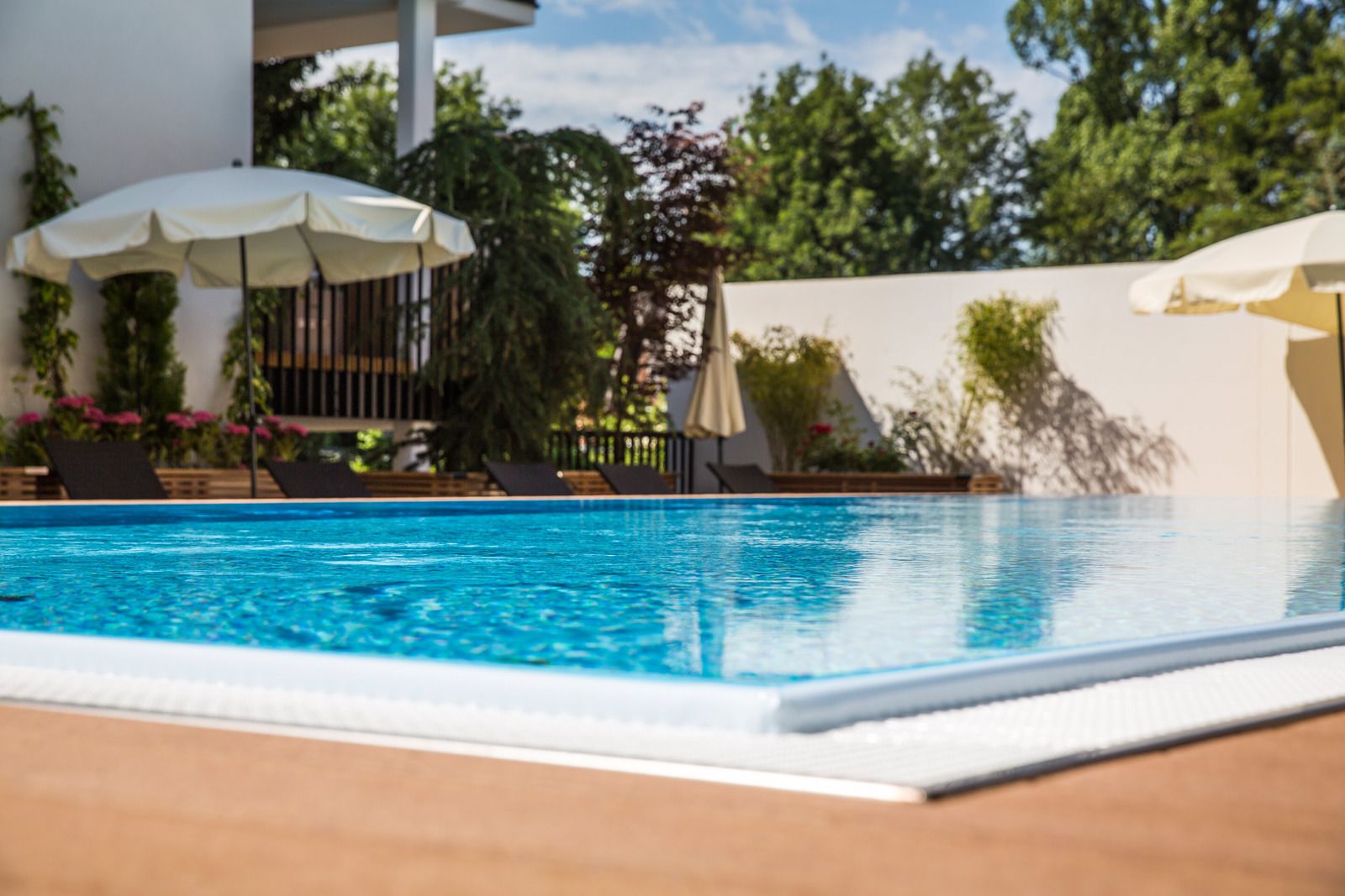 seasonal outdoor pool, pool umbrellas, pool loungers