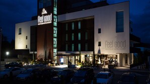 A modern hotel with a prominent 'Feel Good Boutique Hotel Egger' sign. It features a multi-story structure with large windows and a well-lit entrance. -  feel good Resort Wörthersee (Krumpendorf am Woerther See)