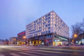 A multi-story hotel with a modern facade, large windows, and a ground-level entrance. - Sihai Grand Hotel (Anshan)