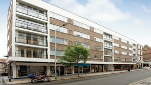 A multi-story building with a flat facade, large windows, and a tree in front. - SACO Holborn - Lamb's Conduit Street (London)