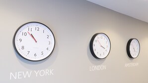 Three clocks labeled with city names: New York, London, and Amsterdam. - SACO Holborn - Lamb's Conduit Street (London)