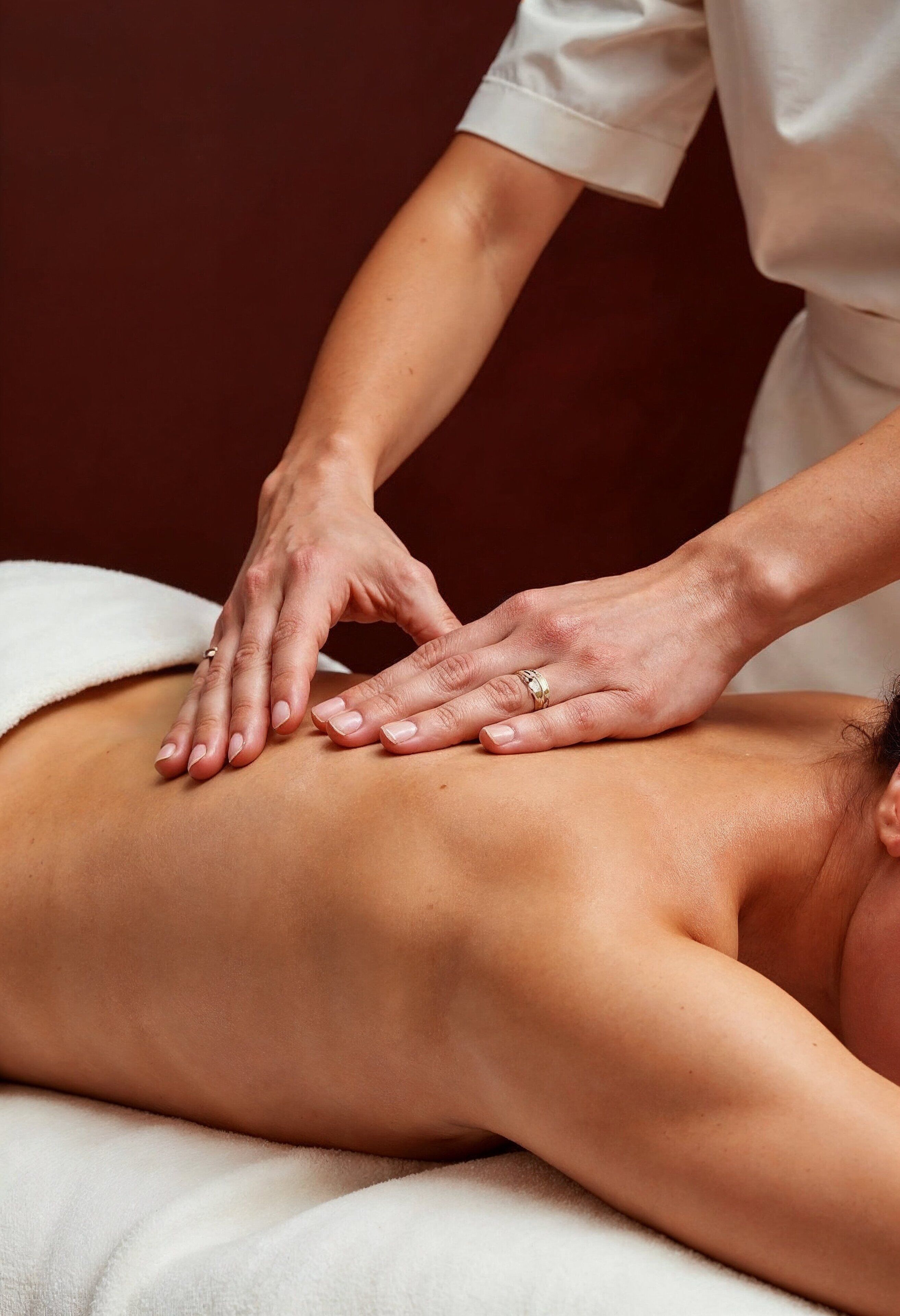 A person receiving a massage on a massage table.