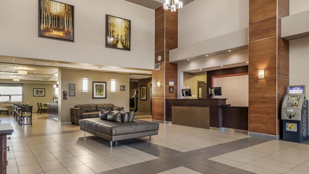 A spacious lobby with a reception desk, seating area, and an ATM machine. - Best Western Plus Moose Jaw (Moose Jaw)