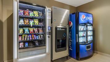A vending machine with a Pepsi logo, a push vending machine with snacks, and an ice dispenser.