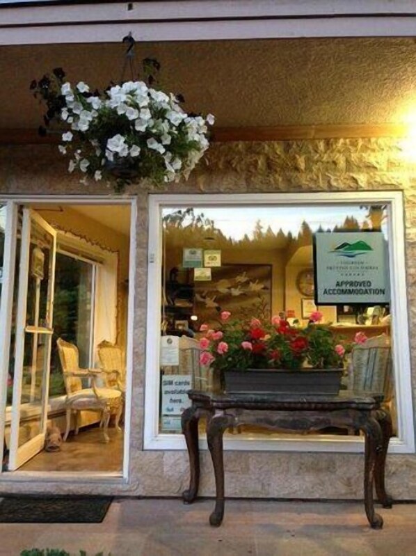 A hotel entrance with a sign indicating approved accommodation.