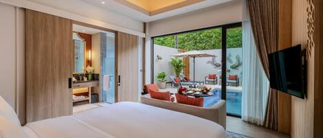 A modern hotel room with a large bed, a TV, a balcony with a pool, and a dining area.