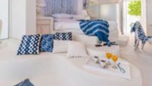A modern bedroom with a bed, a dog, and a dog bowl. - Kouros Home Hotel (Rhodes)