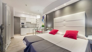 A modern hotel room with a large bed, a desk, and a kitchenette. - Hotel Sun Holidays (Puerto de la Cruz)