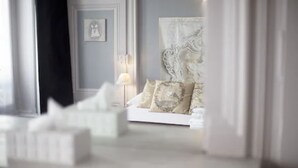 A bedroom with a bed, pillows, a nightstand, and a lamp. - Hôtel de Paris (Lyon)