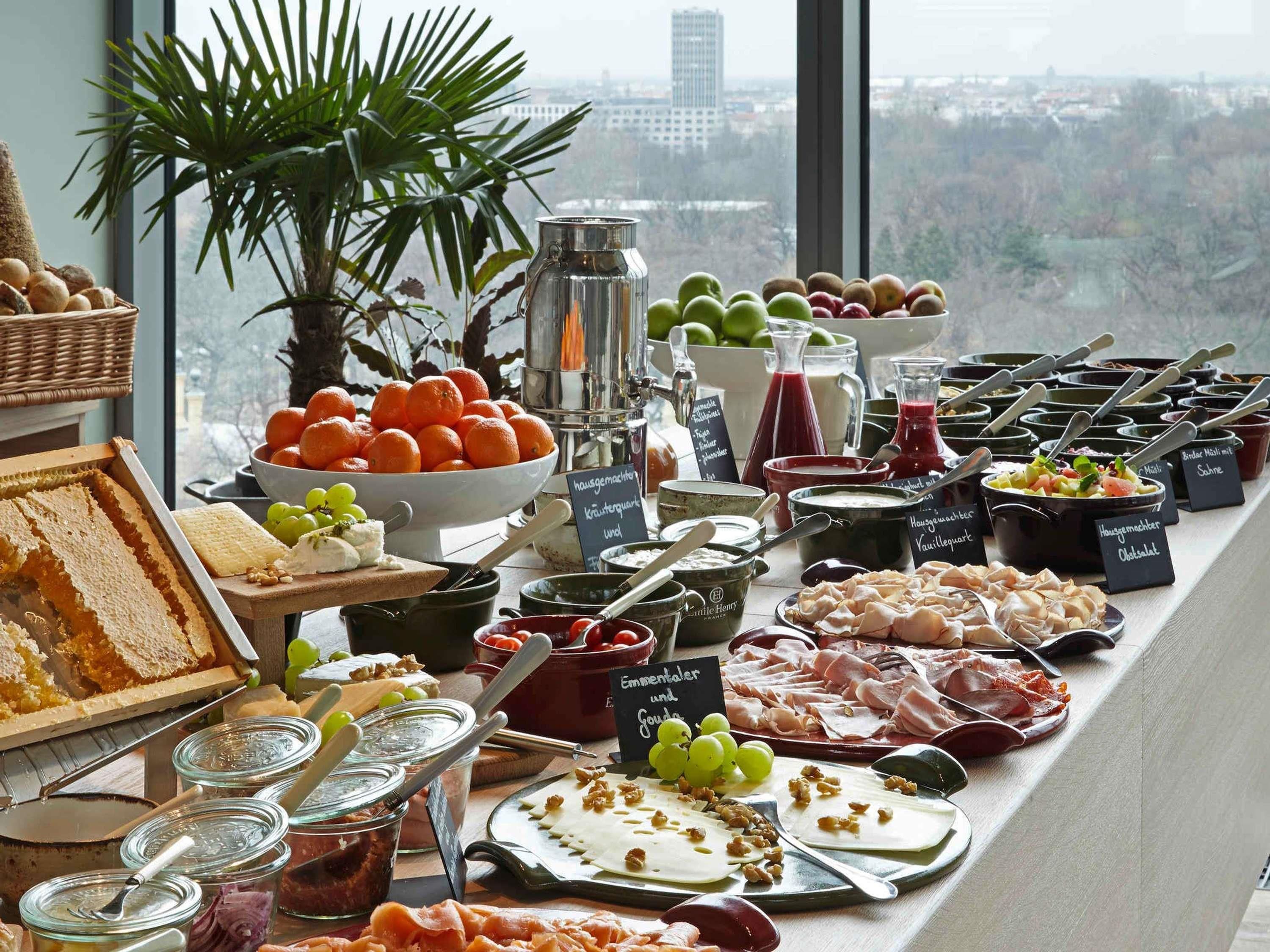 A buffet table with various food items and condiments.