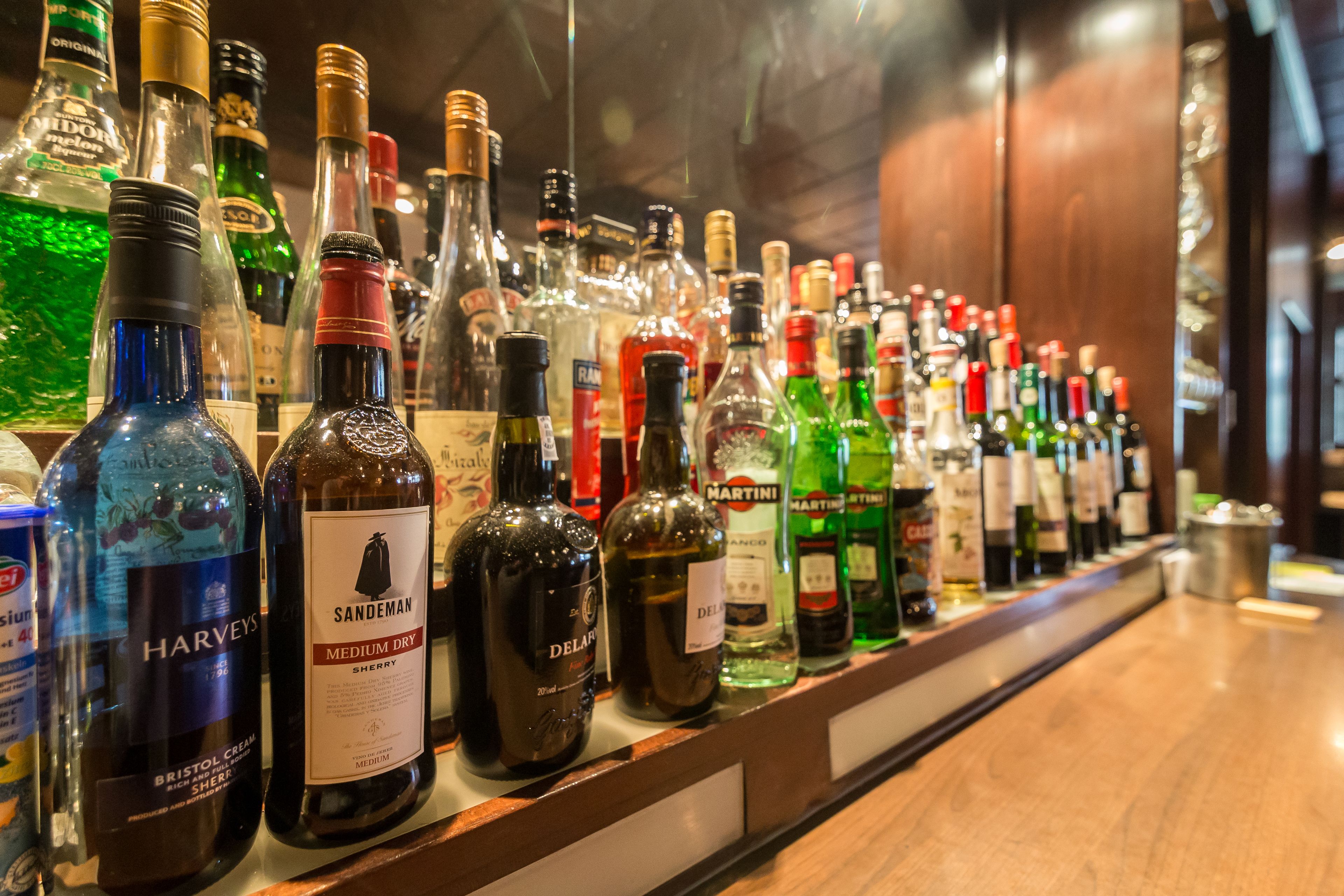 A bar with a variety of liquor bottles lined up on shelves.