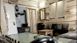 A room with a bed, a desk with a telephone, and a small table. - HIP Hotel (Heidelberg)