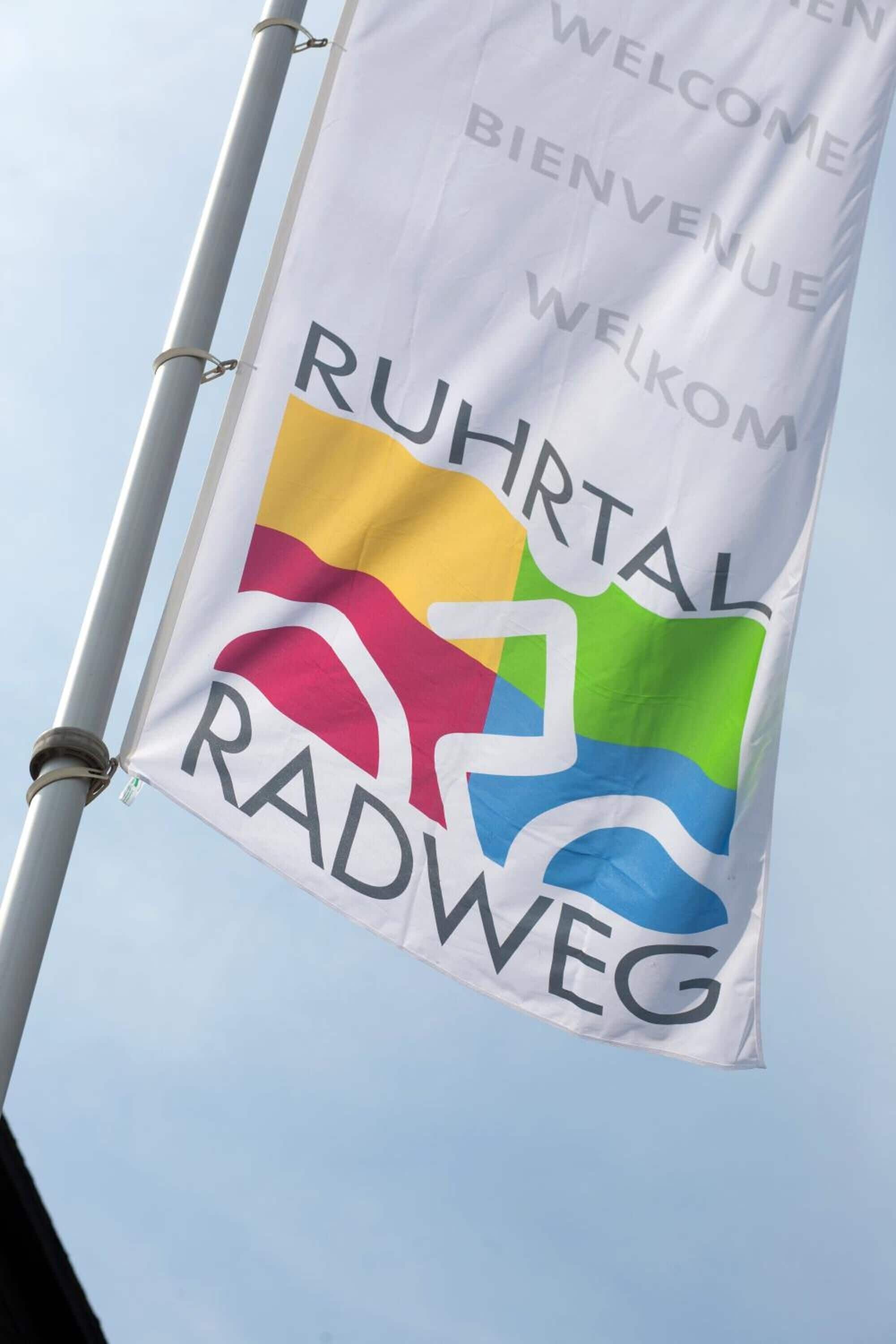 A flag with the text "RUHRTAL RADWEG" and a colorful logo.