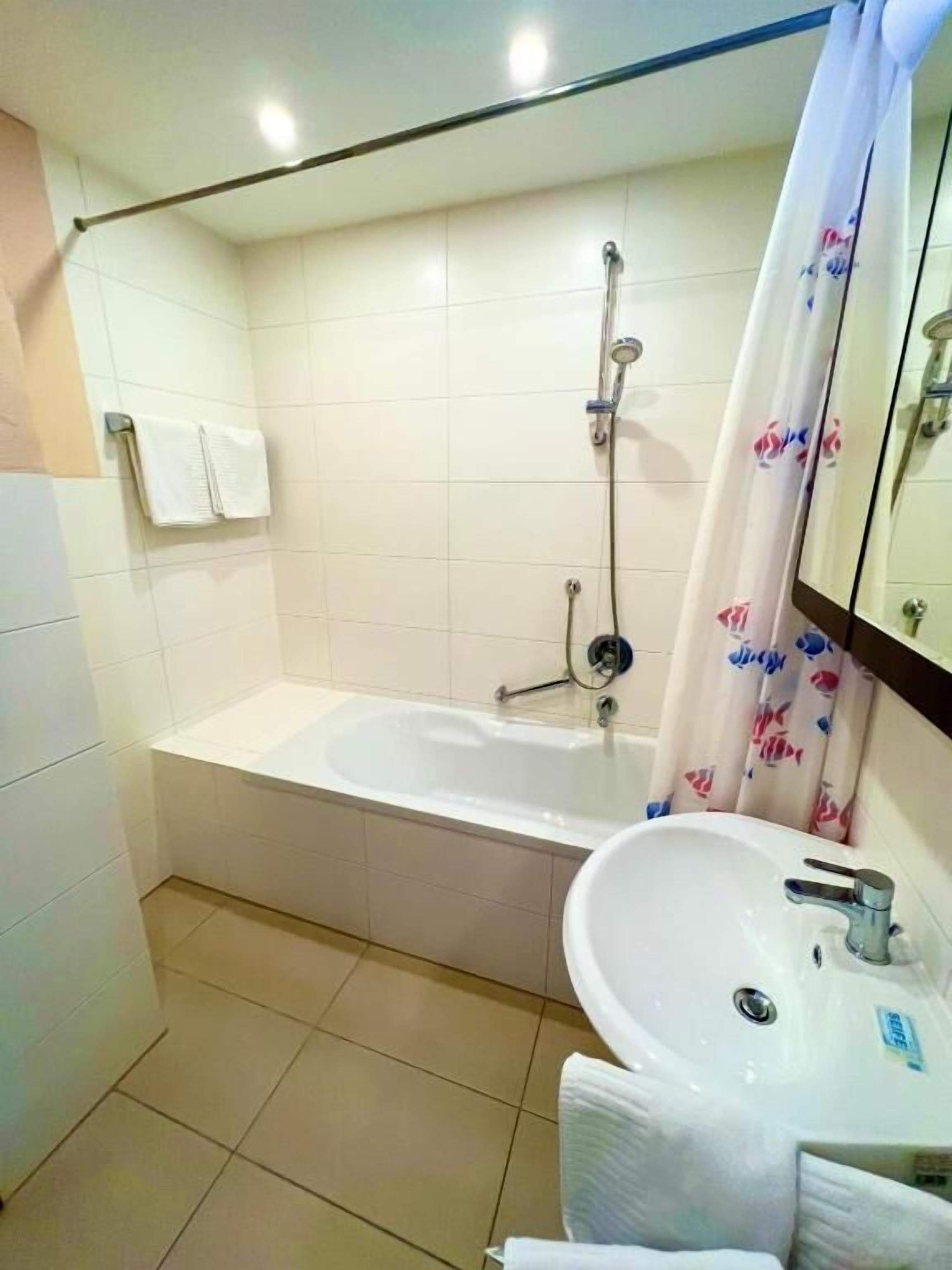 A bathroom with a bathtub, a sink, and a shower.