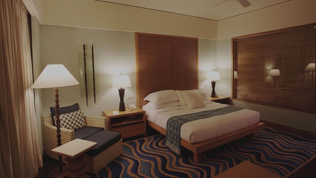 A hotel room with a bed, two nightstands, a chair, a small table, and a large window with blinds. - Hotel Alfa (Neu-Isenburg)