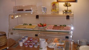 A breakfast buffet with various food items and condiments. - Hotel Alfa (Neu-Isenburg)