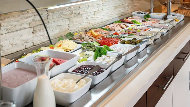 A buffet with various food options including meats, cheeses, and salads. - Wilhelmshaven Ahoi, Sure Hotel Collection by Best Western (Wilhelmshaven)