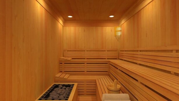 A sauna with wooden benches and a bench with a towel. - Landgasthof Scherer (Wenden)
