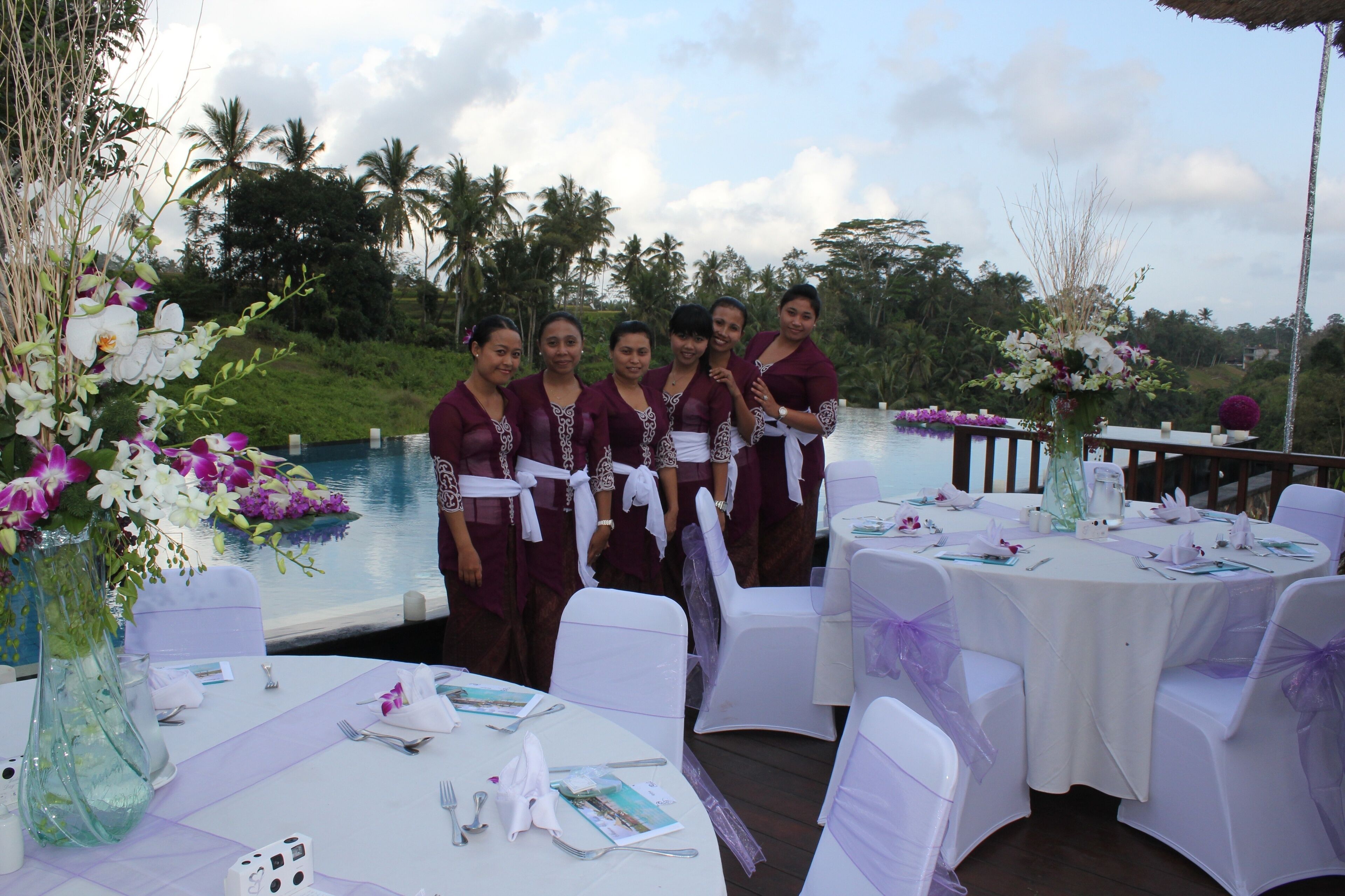 A group of people standing by a table set for a wedding.