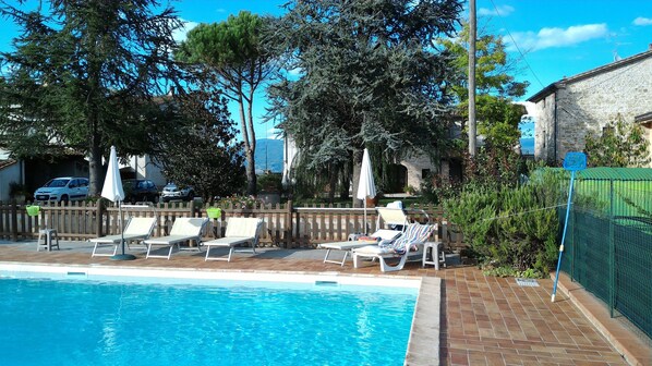 Outdoor pool, pool umbrellas, pool loungers