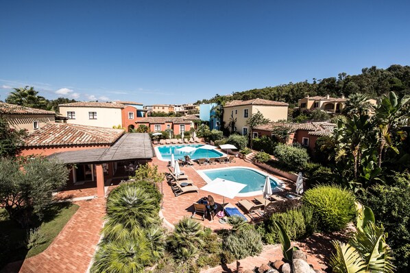 A resort with multiple swimming pools, outdoor seating areas, and lush landscaping. - Borgo degli Ulivi Residence (Tortoli)