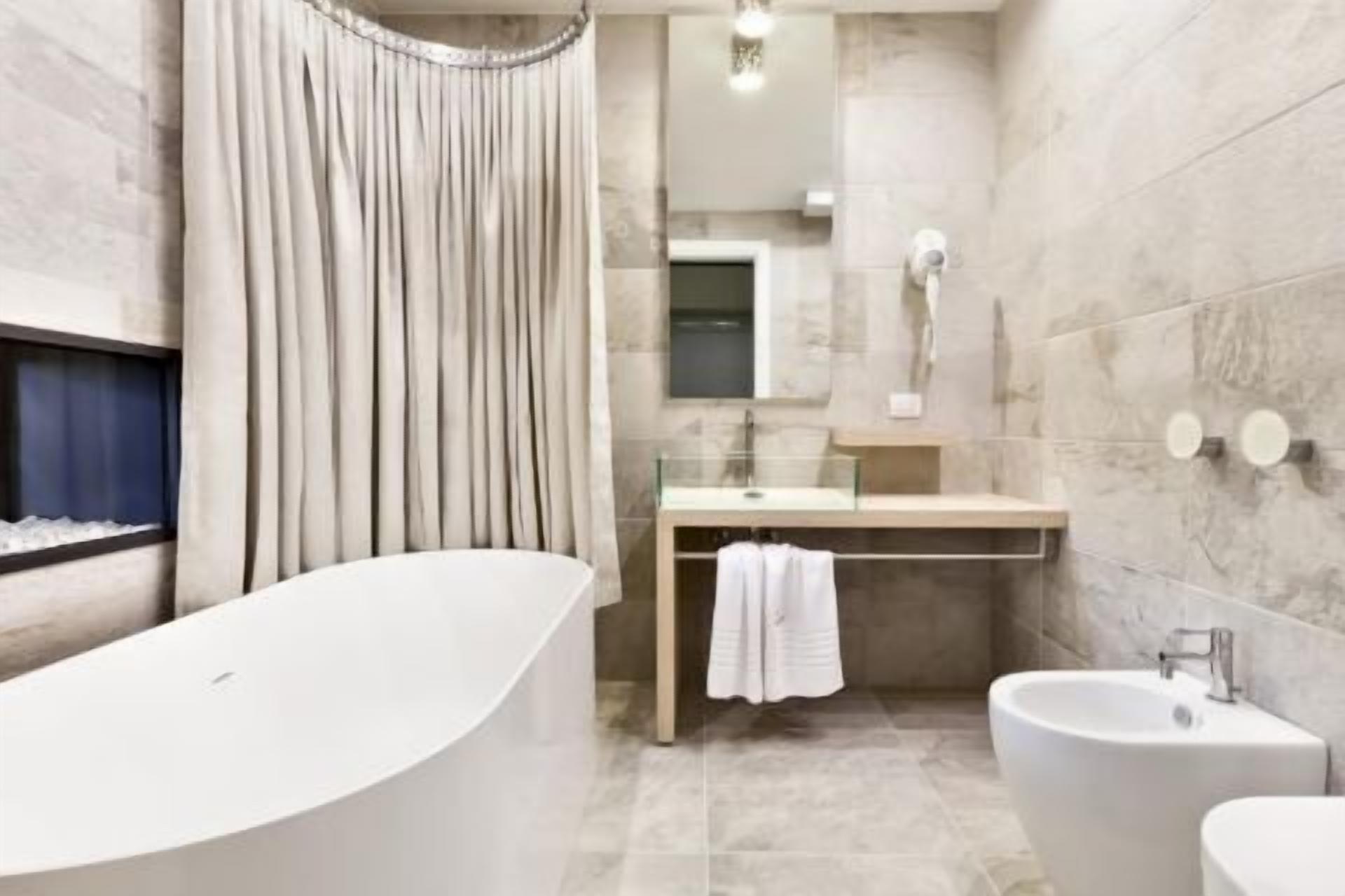 shower, hair dryer, bidet, towels