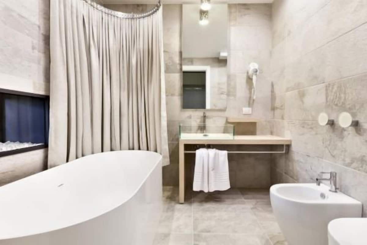 shower, hair dryer, bidet, towels