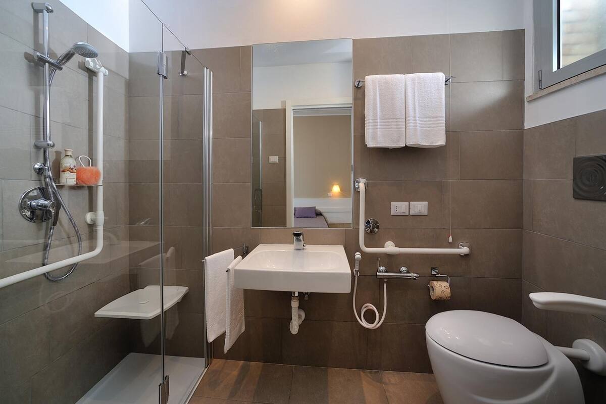 shower, hair dryer, bidet, towels