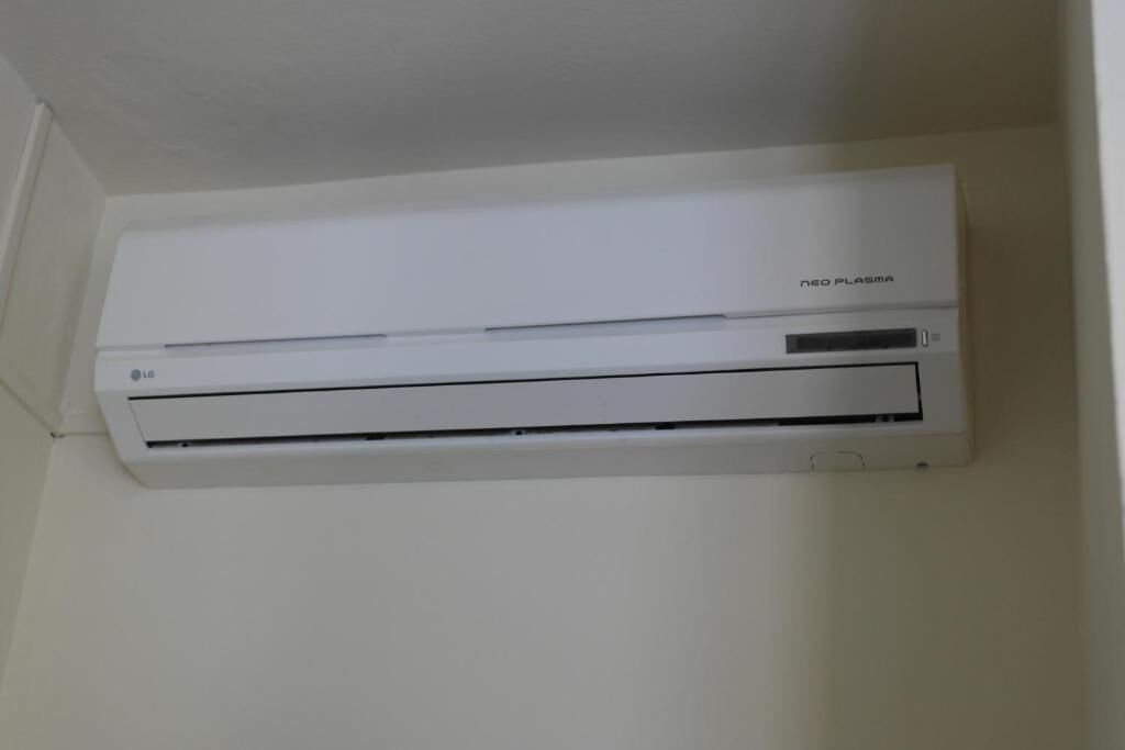 A white air conditioning unit mounted on a wall.