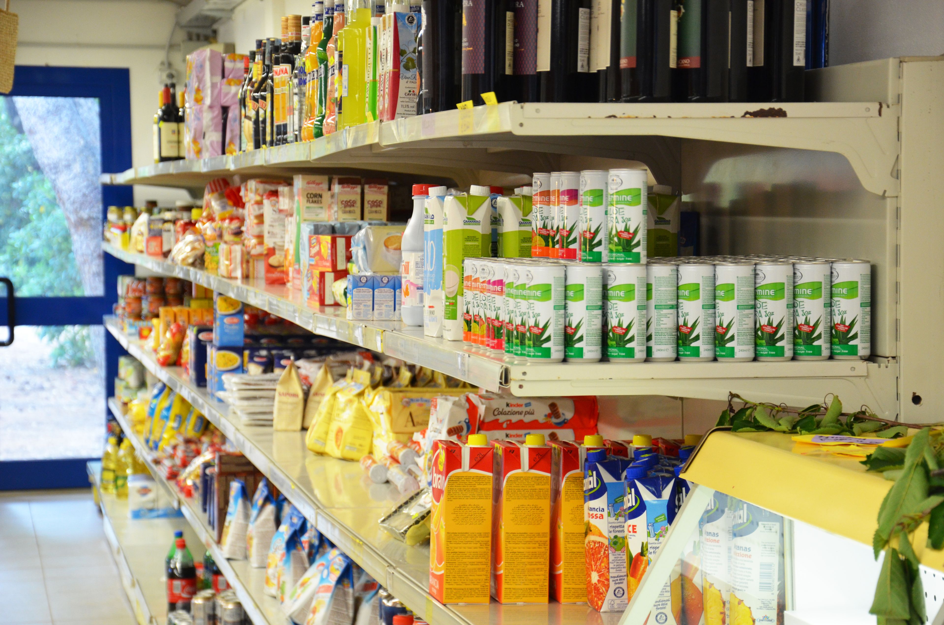 Shelves stocked with various food and beverage products in a store.