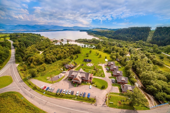 Enjoy serene lakeside views from this property, surrounded by lush greenery and a tranquil lake.