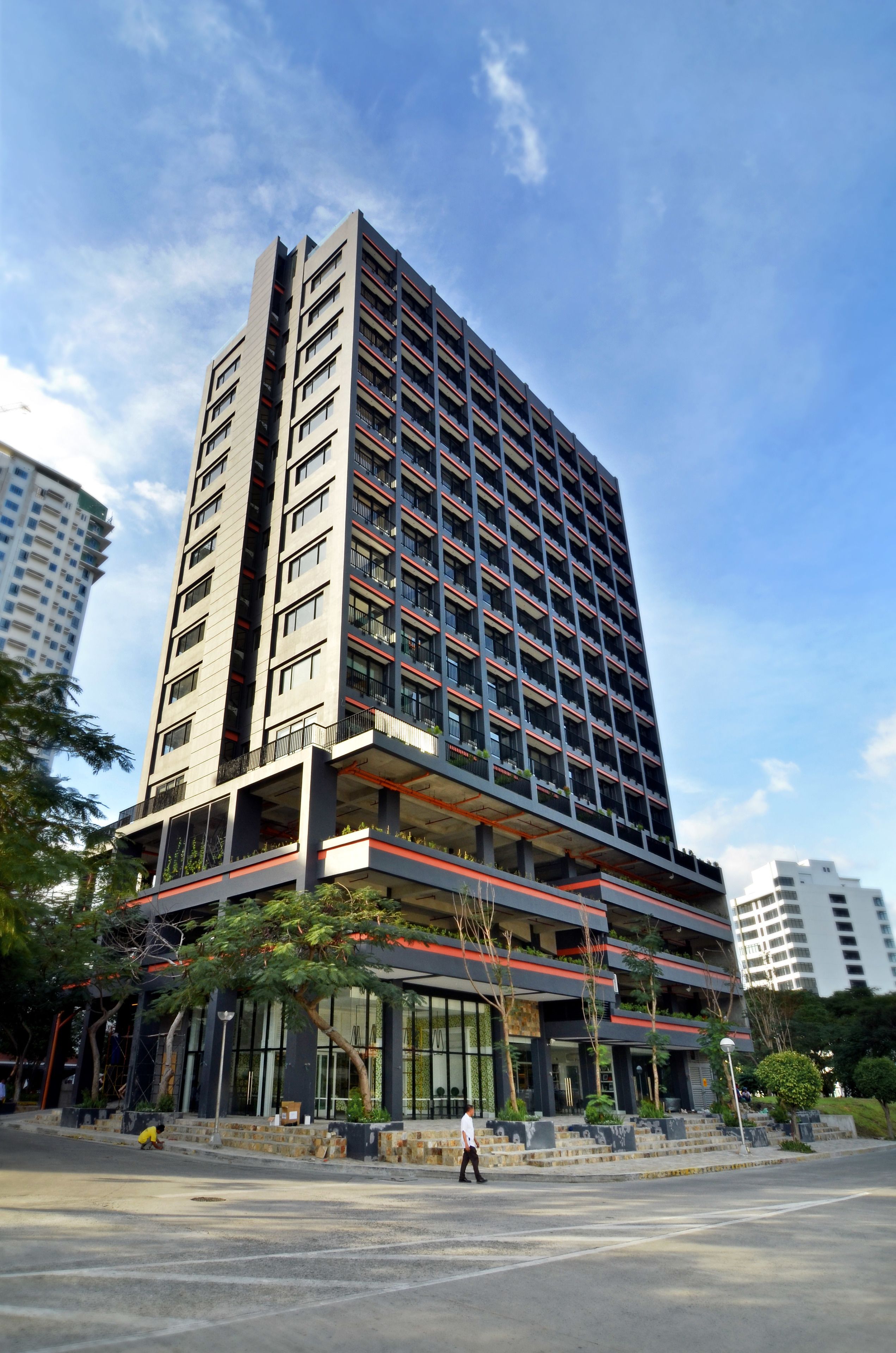 A multi-story hotel with a modern design, featuring balconies, large windows, and a prominent entrance.