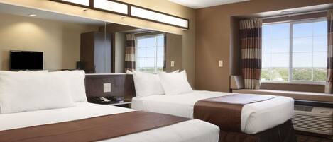 A hotel room with two beds, a flat-screen TV, a large window with curtains, and a view of the city.