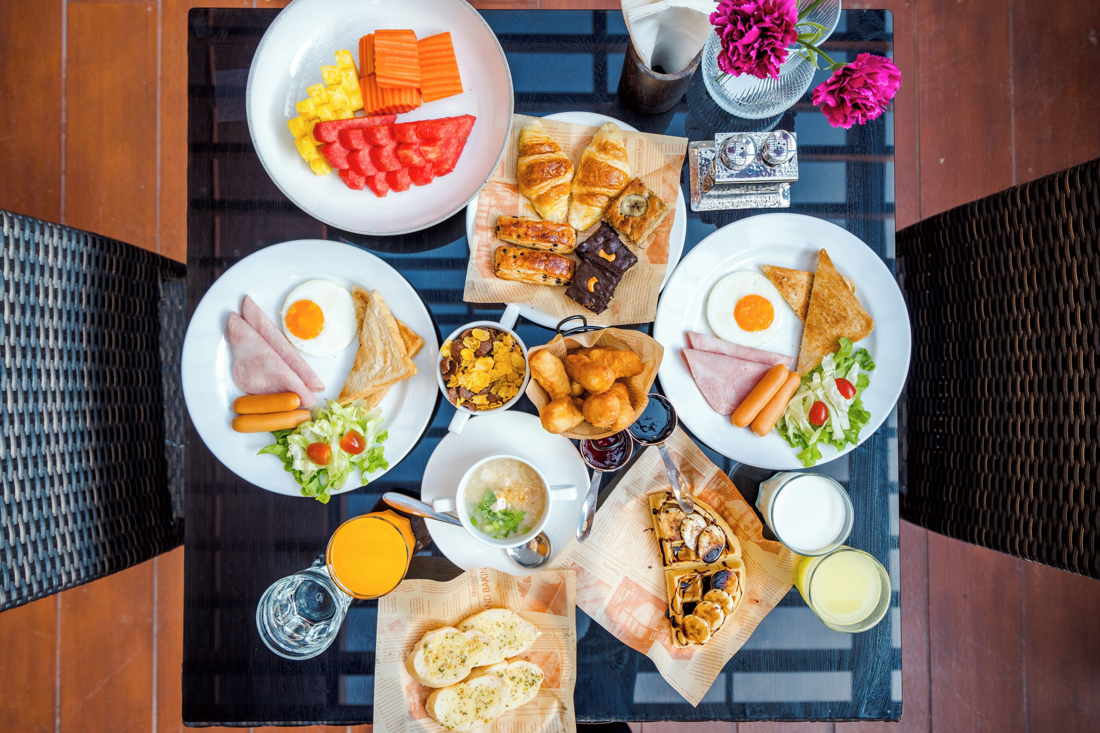 Un bufé de desayuno con diversos platos y bebidas sobre una mesa.