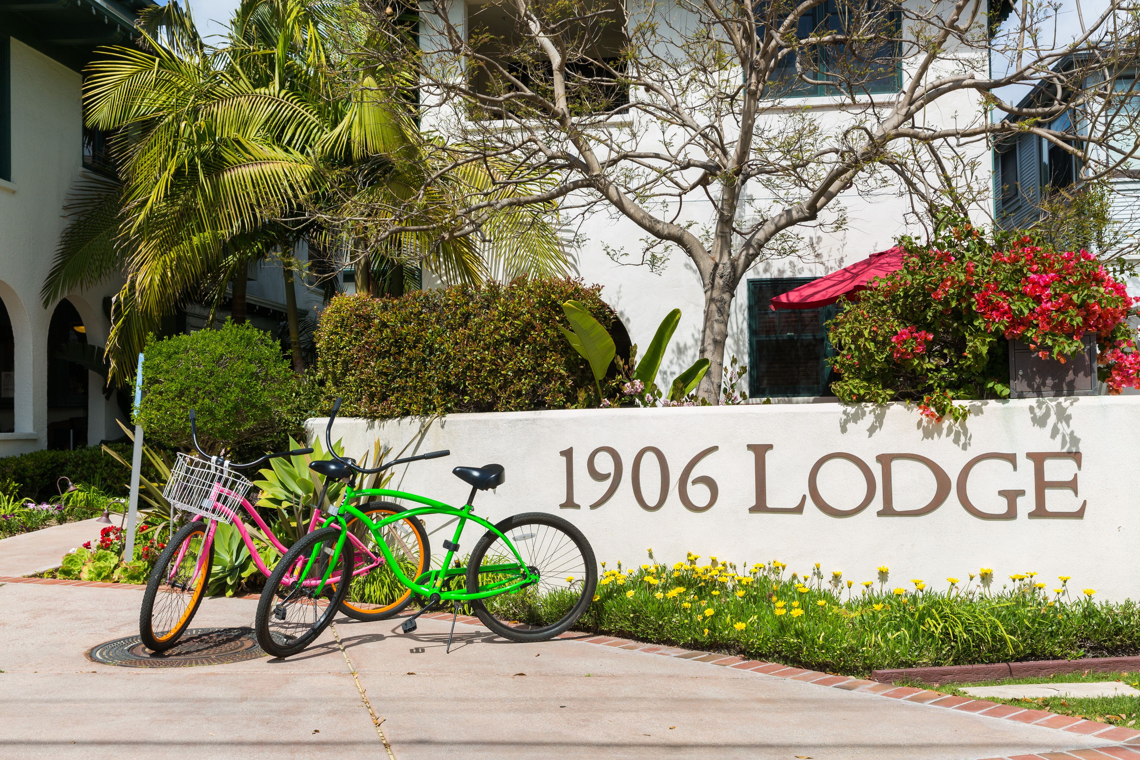 A sign for 1906 Lodge with a bicycle parked in front.