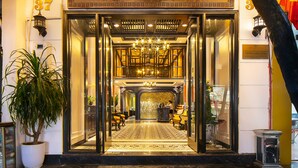 The exterior of the Lavender Central Hotel with a well-lit entrance, a large potted plant, and a visible number '37'. - Lavender Central Hotel & Spa (Hanoi)