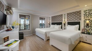A hotel room with two beds, a TV, a balcony, and a desk with a chair. - Lavender Central Hotel & Spa (Hanoi)
