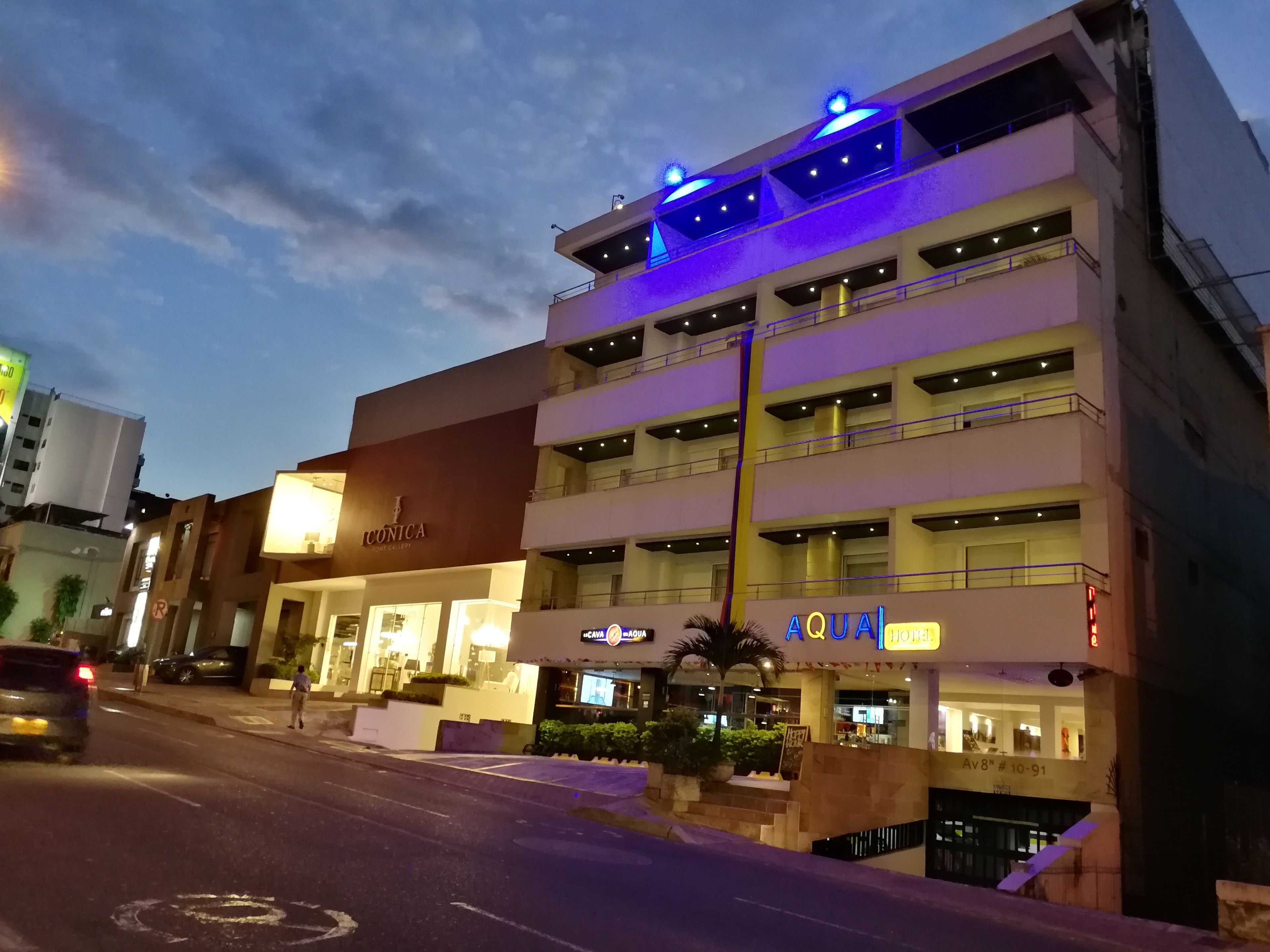 Un hotel de varios pisos con diseño moderno, que cuenta con balcones y una entrada destacada.