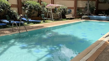 Outdoor pool, open 8 AM to 6 PM, pool loungers