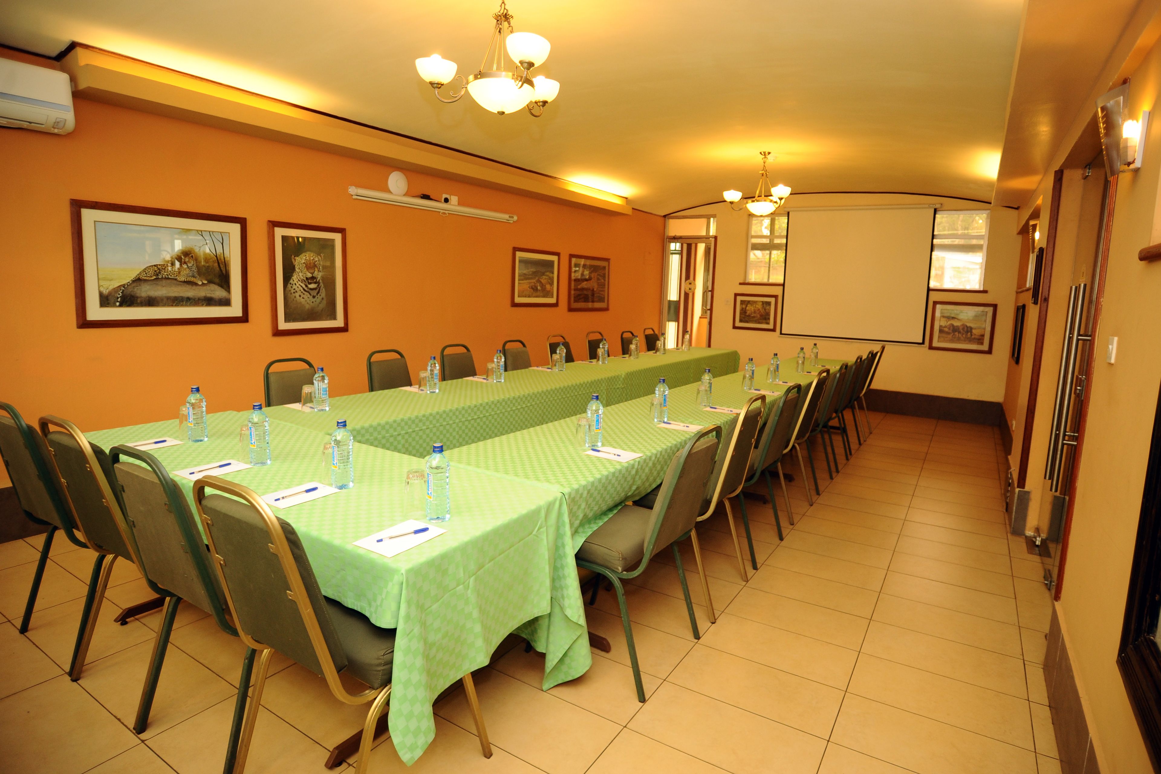 A conference room with a long table, chairs, and water bottles.