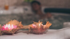 A bathtub with two lotus flower candles and a blurred background. - Tolip Alexandria (Alexandria)