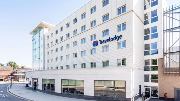 A Travelodge hotel with a modern design, featuring a flat facade, large windows, and a prominent Travelodge logo. - Travelodge Crawley (Crawley)