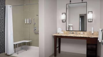 A modern bathroom with a shower, a vanity with a mirror, and toiletries.