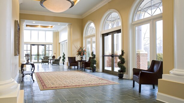 A spacious lobby with high ceilings, large windows, and a central chandelier. - The Resort at Glade Springs (Daniels)