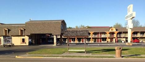 A motel with a sign reading "Motor Lodge" and a signboard advertising free WiFi.
