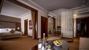 A hotel room with a bed, a dining table with a fruit bowl, and a mirror. - Atlantic Agdal (Rabat)