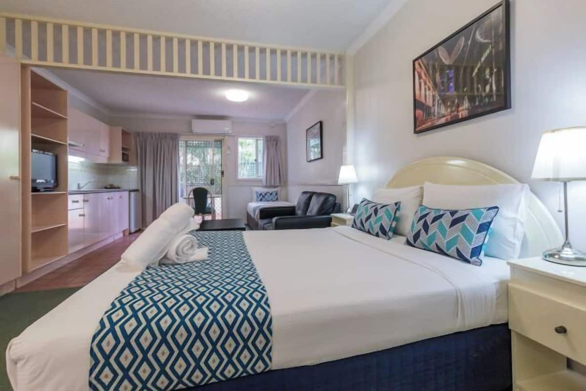 Premium bedding, desk, laptop workspace, blackout drapes