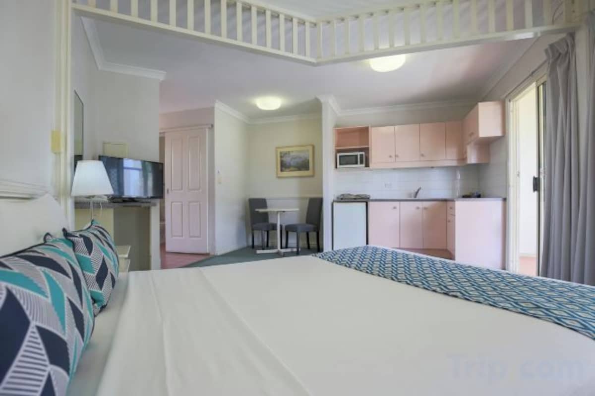 Premium bedding, desk, laptop workspace, blackout curtains