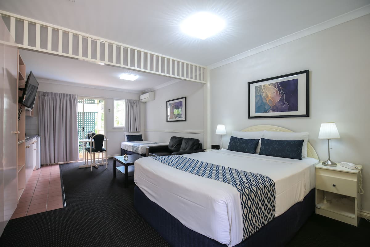 Premium bedding, desk, laptop workspace, blackout drapes