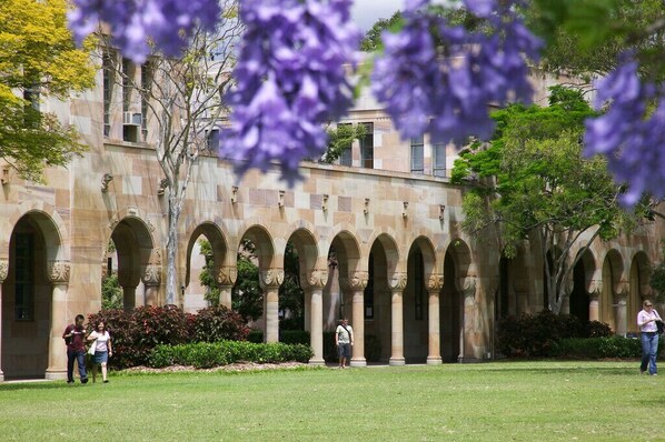 Un patio con una serie de arcos y un edificio al fondo.